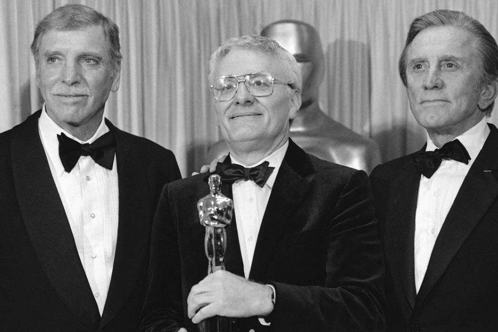Peter Shaffer (centre), with Burt Lancaster (left) and Kirk Douglas, holds his Oscar for best adapted screenplay for Amadeus in 1985. Photo: AP