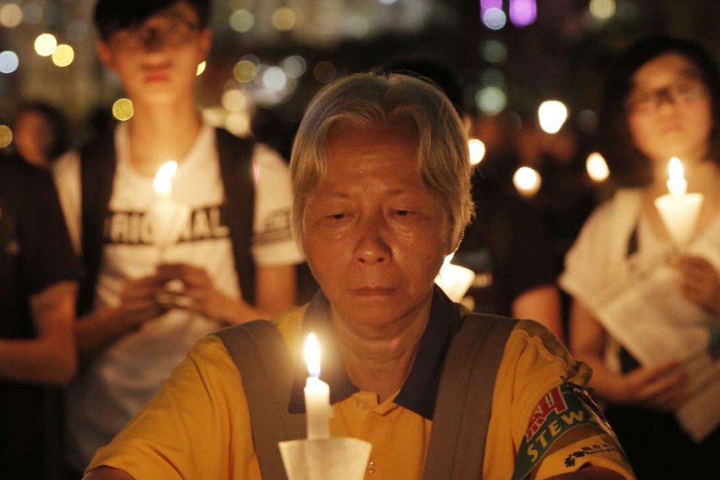 A woman joins tens of thousands of people attending a candlelight vigil at Victoria Park in Hong Kong to commemorate victims of the 1989 crackdown in Beijing. Photo: AP