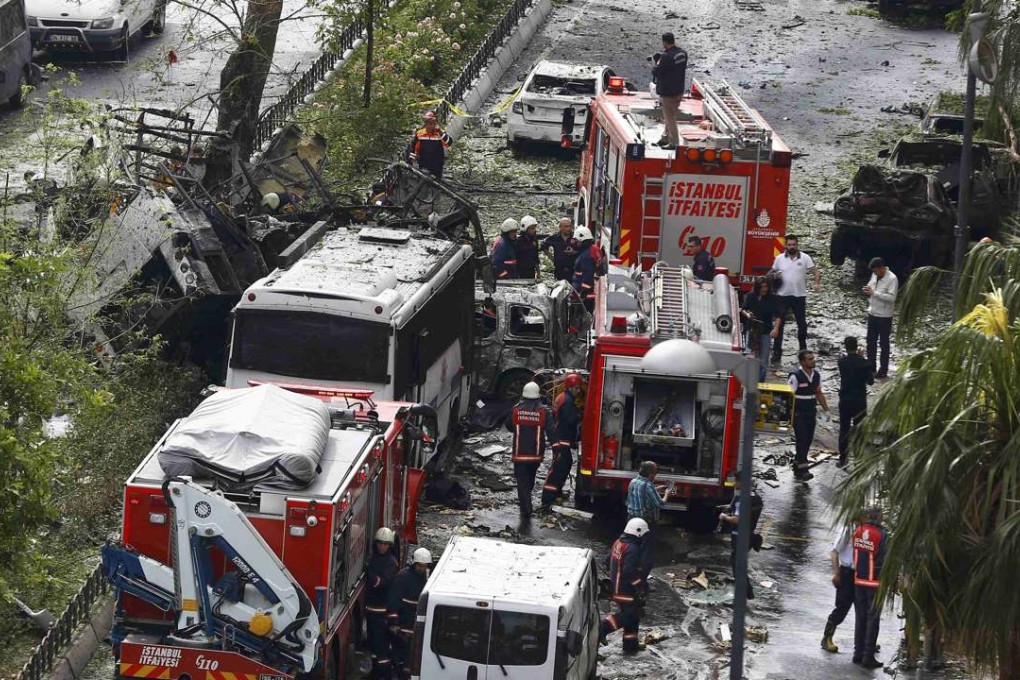 Fire engines stand beside a Turkish police bus which was targeted in a bomb attack in central Istanbul. Photo: Reuters