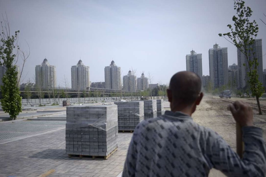 A Chinese worker looks on outside a subway station in Beijing on May 27, 2016. China's exports slumped nearly 2 per cent in April compared to the same month last year, as imports fell almost 11 per cent, officials said on May 8. Photo: AFP