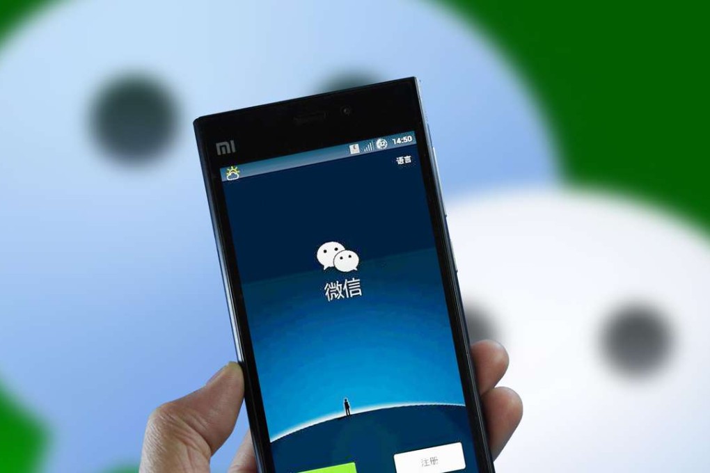 A mobile phone user displays the messaging app Weixin, or WeChat, of Tencent on his smartphone in Jinan city, east China's Shandong province, on February 8, 2015. Photo: Imaginechina