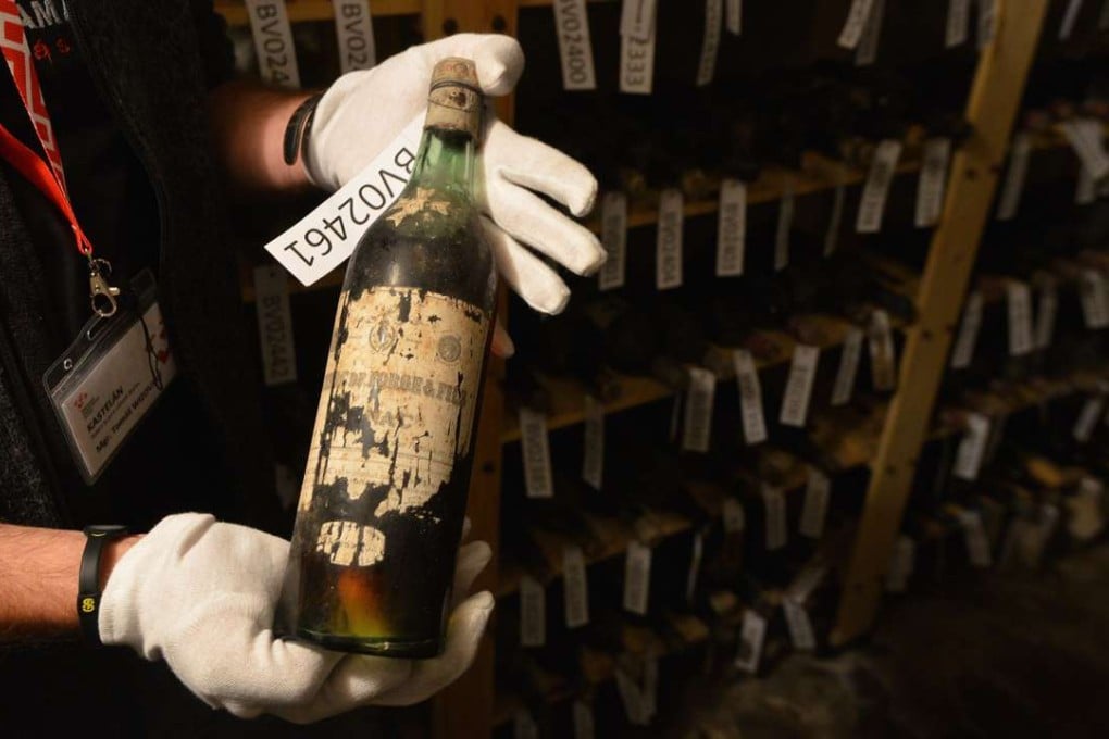 Tomas Wizovsky, castellan of Becov castle in the Czech Republic, holds a bottle of recently discovered 19th-century wine. Photo: AFP