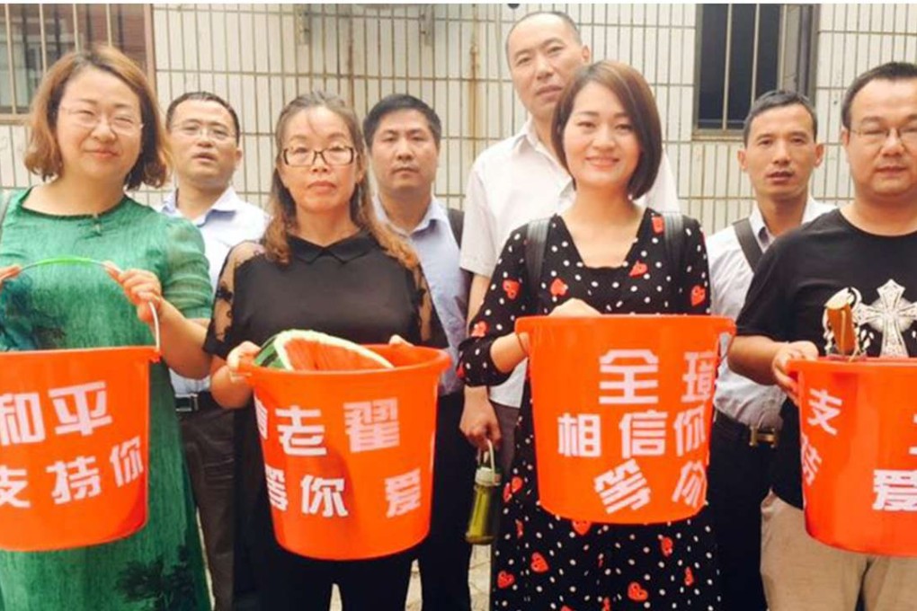 Wives and advocates of detained rights lawyers mount a peaceful protest in support of the detainees on Monday. The buckets are covered in messages of support. Photo: SCMP Pictures