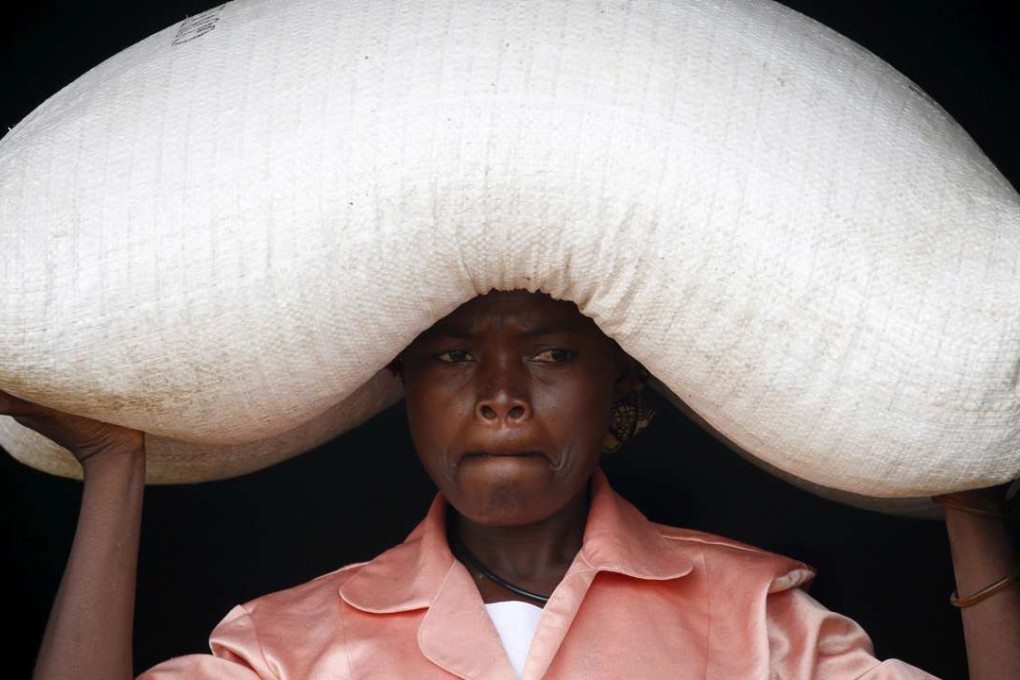 A woman carries food aid distributed by the United Nations World Food Progamme in Malawi. Photo: Reuters