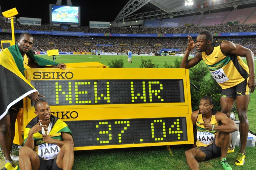 From left, Jamaica's Nesta Carter, Michael Frater, Yohan Blake and Usain Bolt pose by the stop clock displaying their world record time for the 4x100 metres relay at the world championships in Daegu, south Korea, in 2011. Photo: AFP