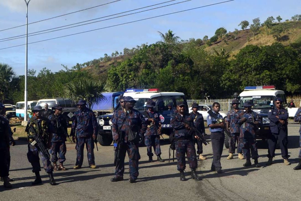 This picture provided by the PNGFM News shows police standing guard as students get ready to march from the University of the Papua New Guinea in Port Moresby. Photo: AFP