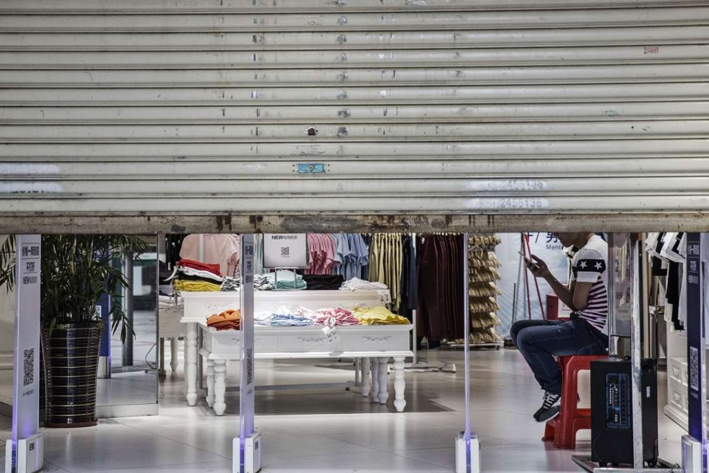 A partially shuttered clothing store in Huizhou, Guangdong province. If the rate of return on China’s state net assets can be improved by 1 per cent under professional management, GDP could be increased by an estimated 1.5 percentage points. Photo: Bloomberg