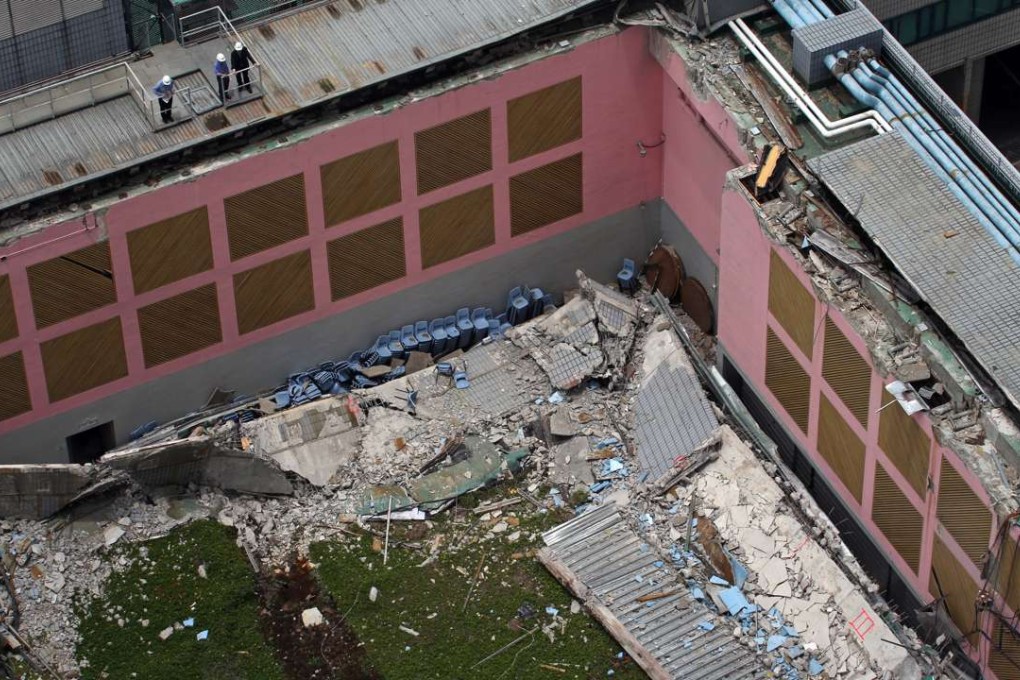 Investigators examine the site of the roof collapse at City University. Photo: Felix Wong