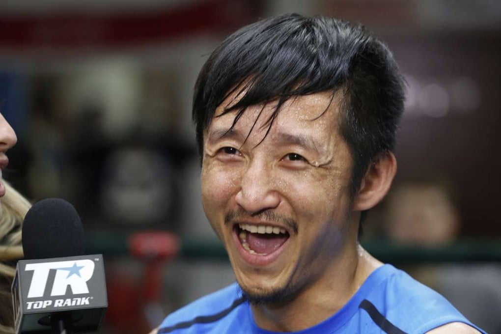 Zou Shiming smiles during a TV interview after working out at Mendez Gym in New York. Photos: AP