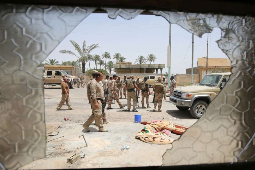 Iraqi soldiers patrol the streets of Saqlawiyah, northwest of Fallujah, on Wednesday, during an operation to regain territory from the Islamic State group. Photo: AFP