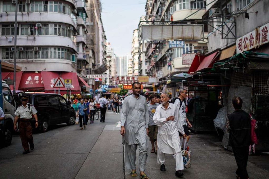 Pedestrians walk along a road in Kowloon. Hong Kong’s geographic position on the edge of China and at the centre of Asia is the result of strategic design. Photo: AFP