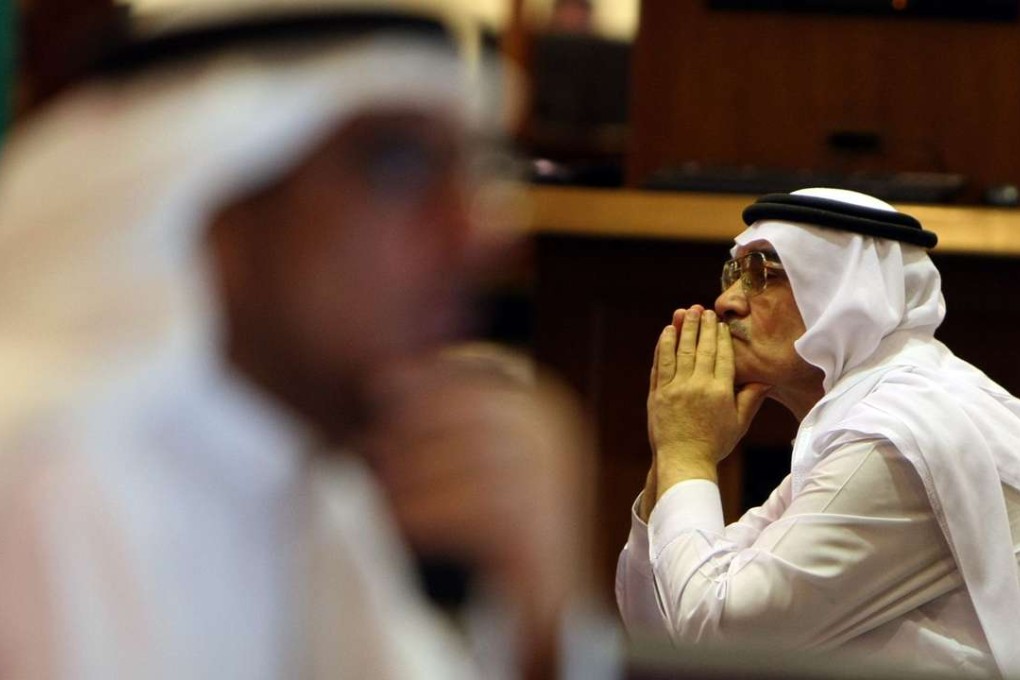 An investor follows market movement at the Dubai Financial Market. Photo: AFP/KARIM SAHIB