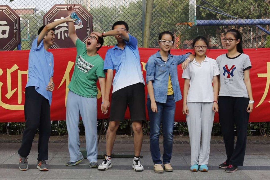 Students pose for photos after taking their university entrance exam in Beijing. Some 9.4 million students took part in the exam across the country this year. Photo: Xinhua
