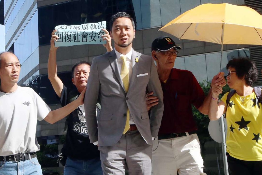 Tsang, flanked by supporters, outside District Court in Wan Chai. Photo: David Wong