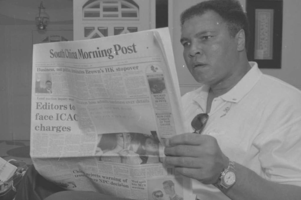 Muhammad Ali reads the South China Morning Post during his visit to Macau in 1994. Photos: SCMP pictures