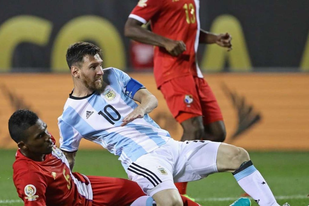 Lionel Messi of Argentina is pulled down by Panama’s Roderick Miller during their Copa America match. Photos: AFP