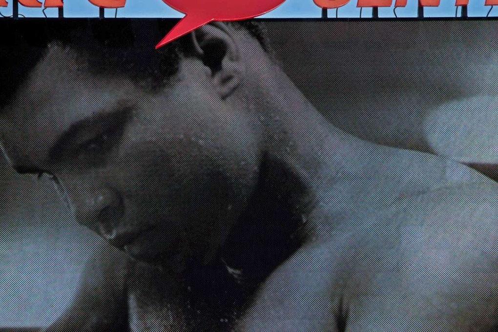 A large screen projects images of boxing legend Muhammad Ali in Louisville, Kentucky during his memorial service. Thousands of people from near and far were expected to line the streets of Muhammad Ali's hometown Louisville on Friday to say goodbye to the boxing legend and civil rights hero. Photo: AFP