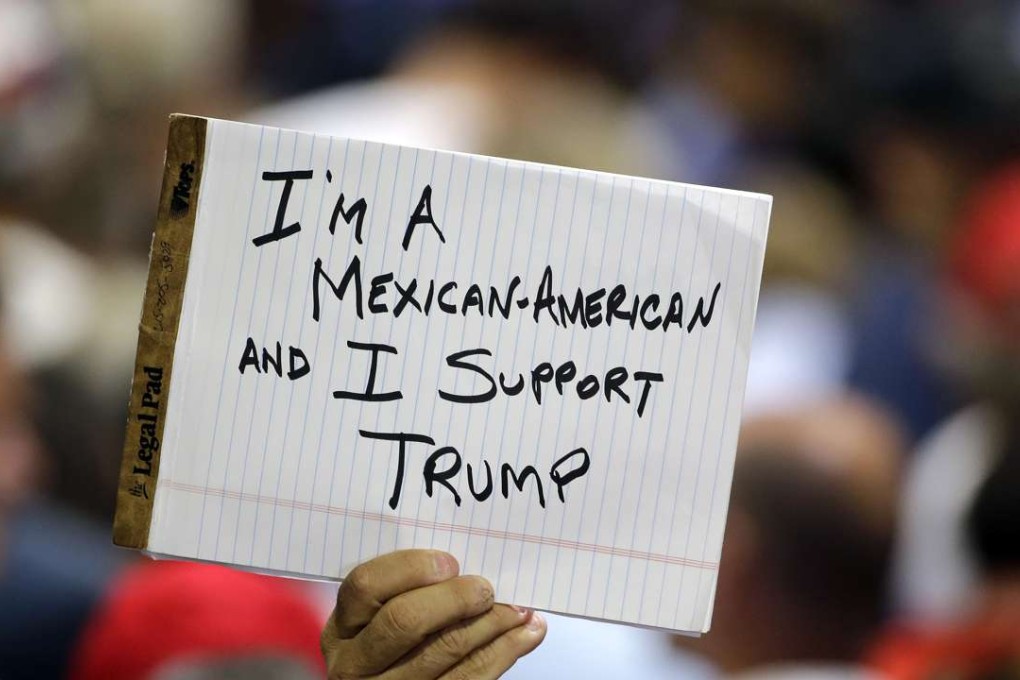 A supporter of Republican presidential candidate Donald Trump holds up a sign during a campaign stop on June 11, 2016, in Tampa, Florida. Photo: AP
