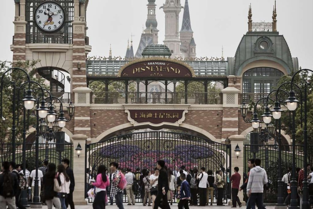 Visitors walk past a gate at Shanghai Disneyland on May 7, when it began trial operations. Photo: Bloomberg
