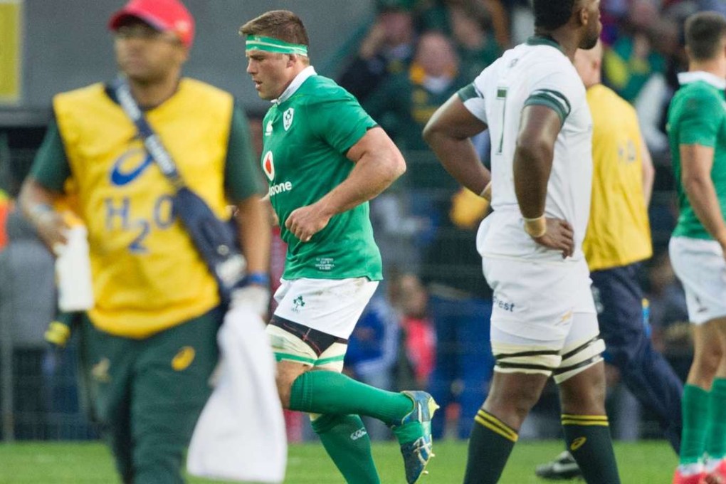 CJ Stander (C) from Ireland walks off the field after being given a red card for an illegal tackle on Pat Lambie(not visible), of the Springbok (South Africa) team during their test match at Newlands Stadium, in Cape Town on June 11, 2016. This is the first of three tests the Irish are playing against South Africa. / AFP PHOTO / RODGER BOSCH
