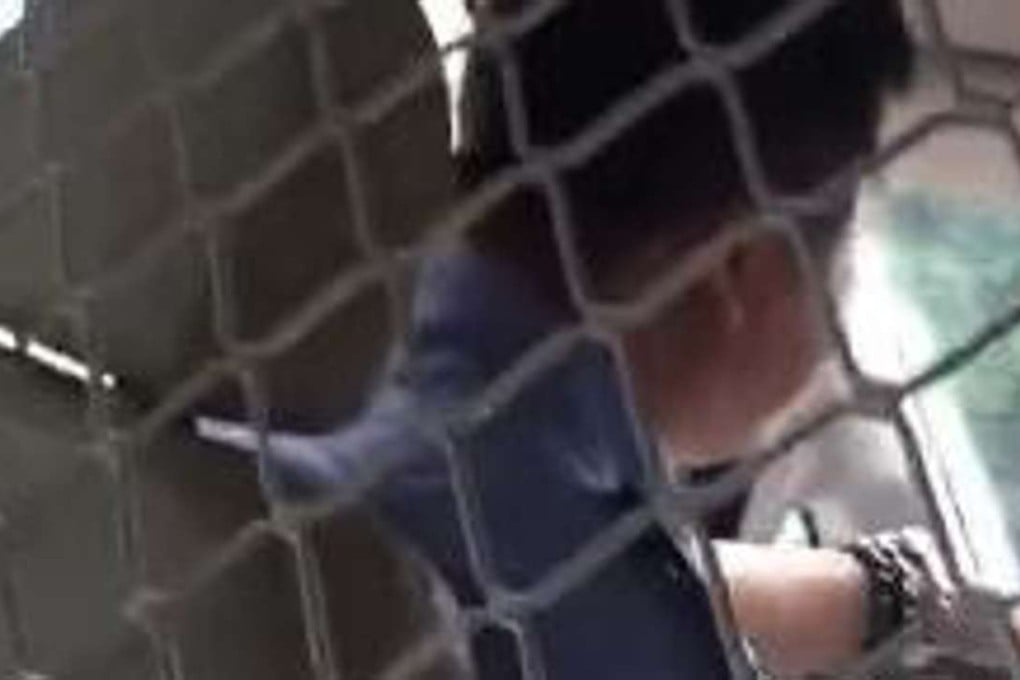 The Chinese police officer has been suspended from duty after being secretly filmed on a mobile phone humiliating two women during questioning. Photo: SCMP Pictures