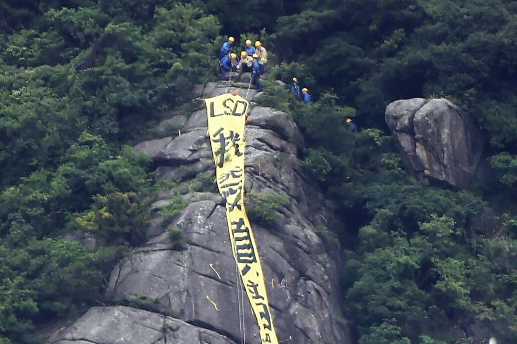 The offending democracy banner put up on Beacon Hill raises questions of law. Photo: Sam Tsang