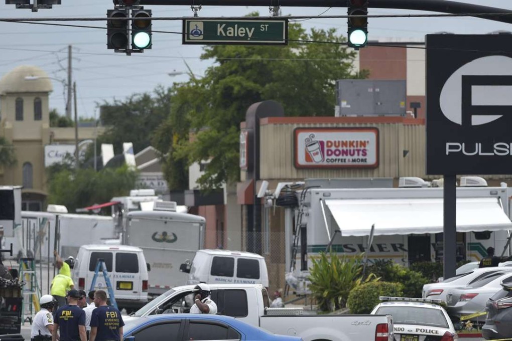 Police and investigators work near the area of the mass shooting at the Pulse nightclub. Photo: AFP