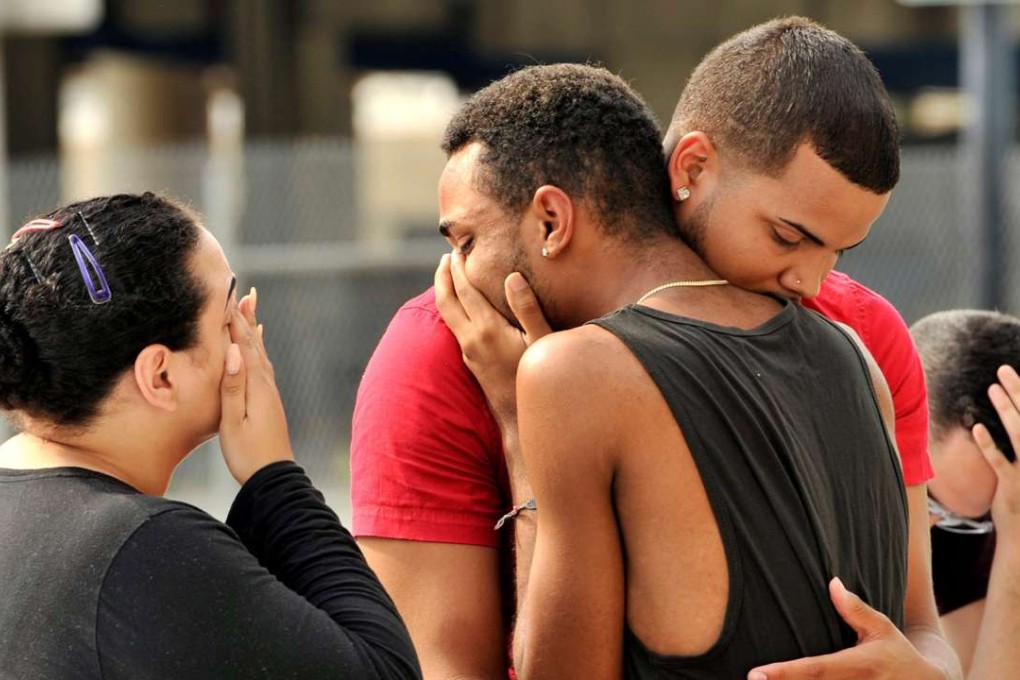 Friends and family members of victims embrace outside the Orlando Police Headquarters amid the investigation into the massacre at the Pulse nightclub. Photo: Reuters