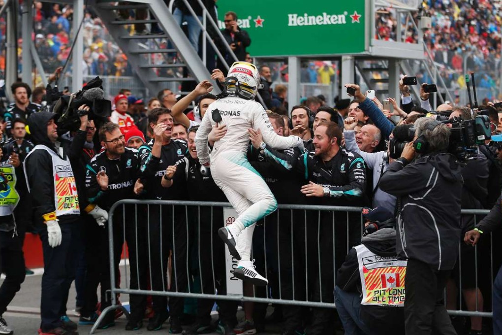 Lewis Hamilton celebrates with his team after winning the Canadian Grand Prix. Photo: AFP