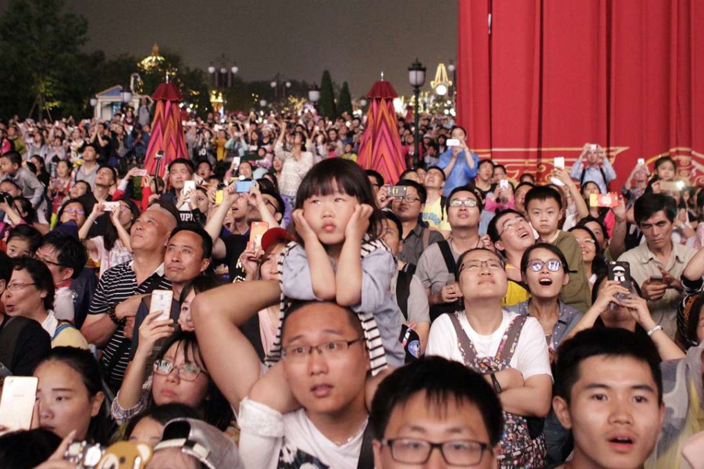 People watch a light and fireworks display near the Enchanted Storybook Castle at Shanghai Disneyland during trial operations in late May. Photo: AP