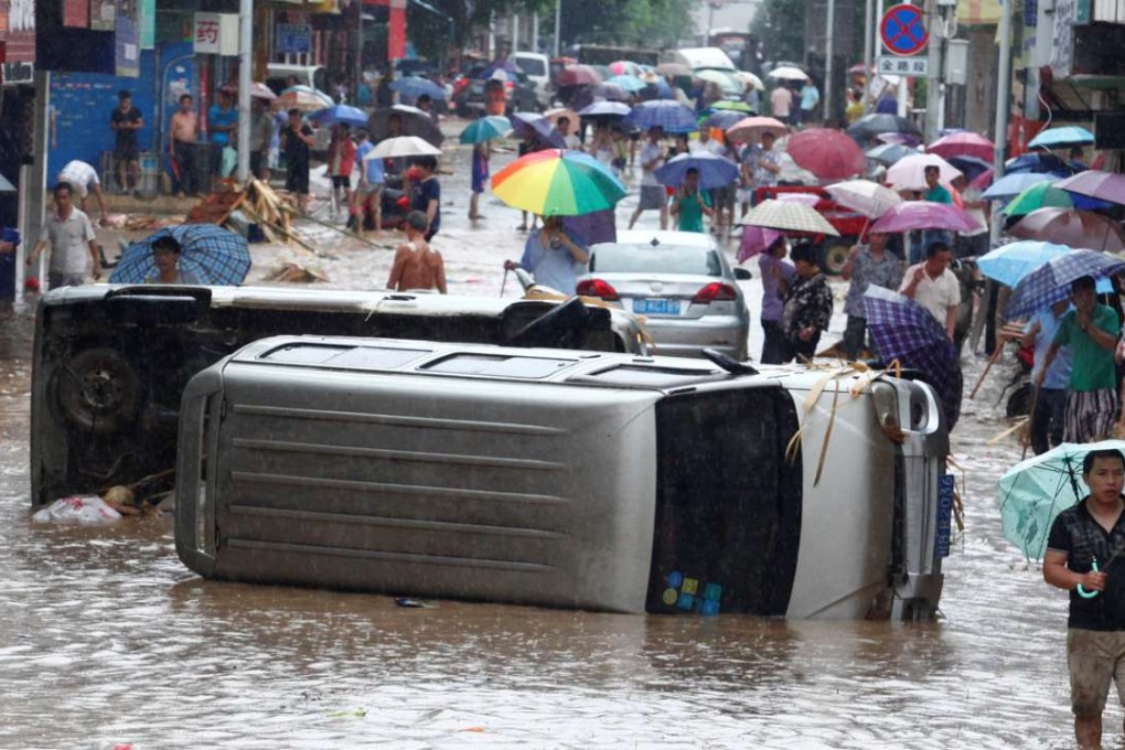 Vehicles lie overturned in a flooded street in Liuzhou, in Guangxi on Tuesday. Photo: Reuters