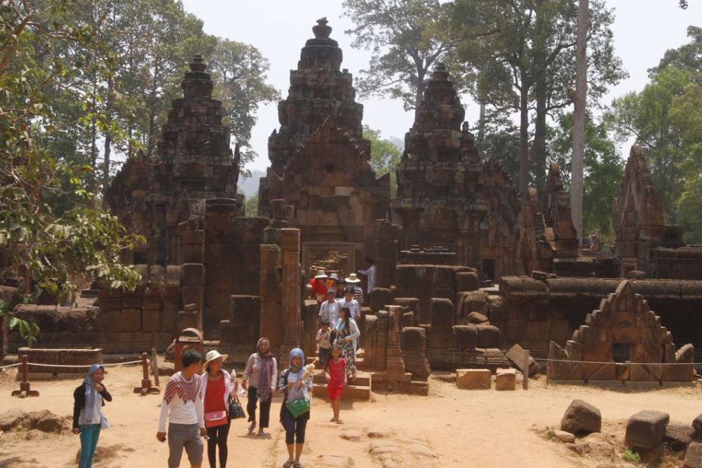 Tourists walk at Banteay Srey temple of Angkor Wat complex in Siem Reap province, Cambodia. Photo: AP