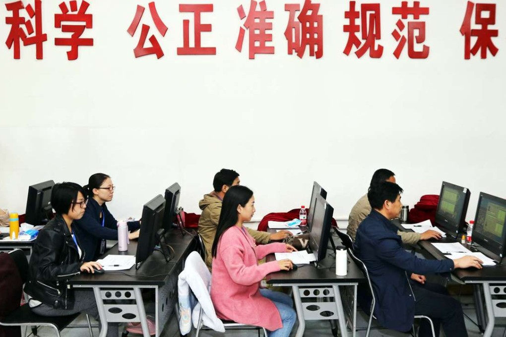 China’s education officers monitor students taking their university entrance exam in Zhengzhou, Henan province, earlier this month. Photo: AFP