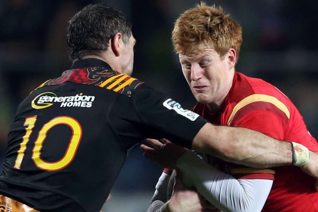 Rhys Patchell of Wales is tackled by Stephen Donald of the Waikato Chiefs. Photos: AFP