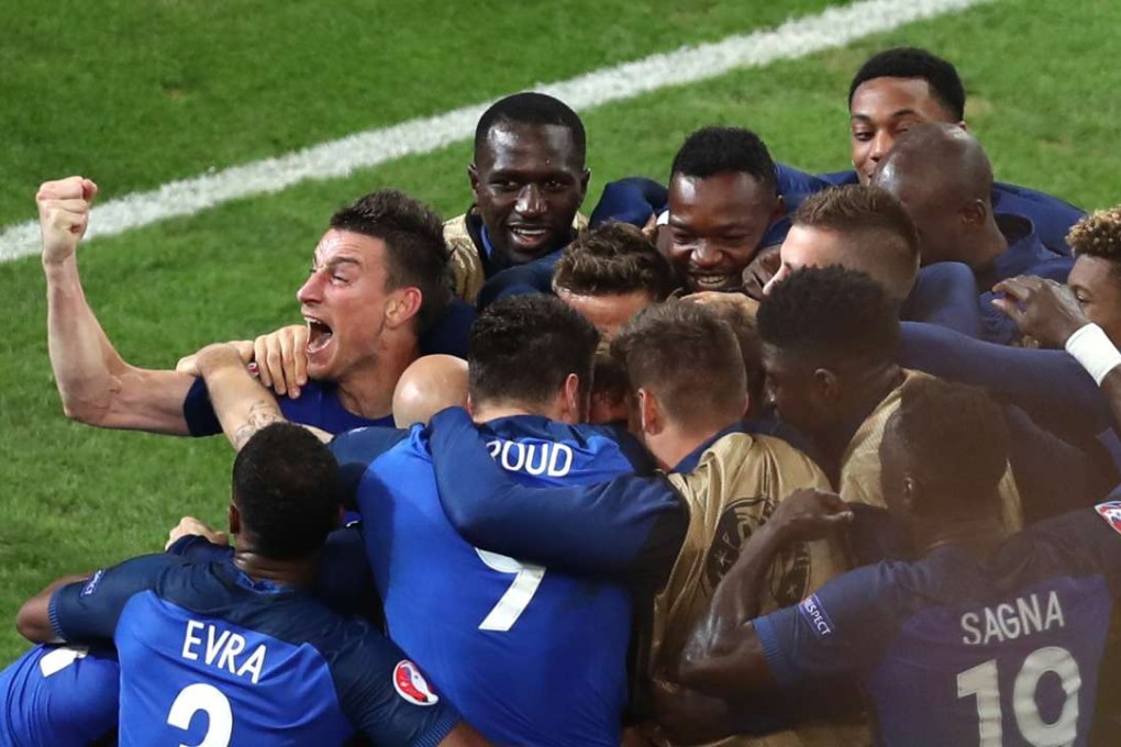 France's Antoine Griezmann celebrates with team mates after scoring the opening goal (AP Photo/Claude Paris)