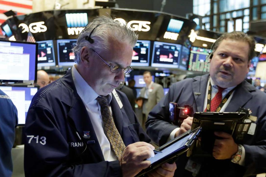 Traders in the New York Stock Exchange work the floor as assetmanager BlackRock introduced a China A-shares ETF in the exchange. Photo: AP