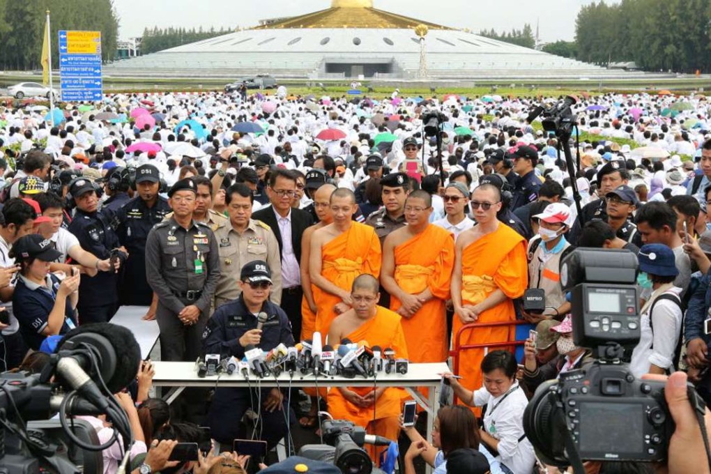 Thai police officials and Wat Dhammakaya monks jointly hold a press conference at the monastery in Pathum Thani province on Thursday. Photo: EPA