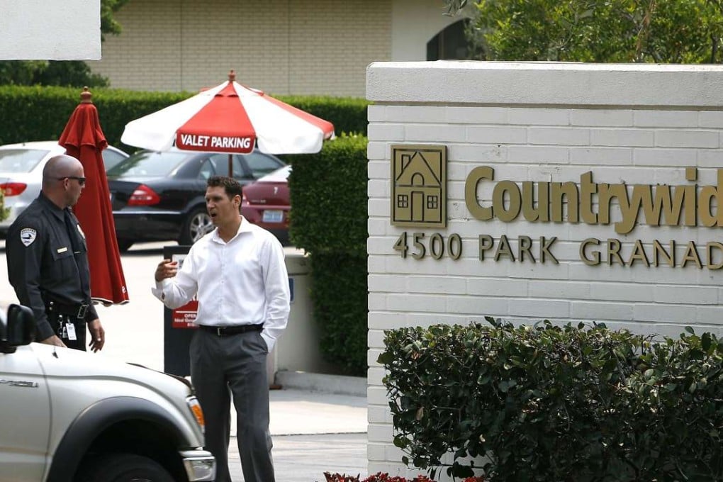 Employees talk at Countrywide Financial headquarters' main gate in Calabasas, California in 2008. Photo: AP