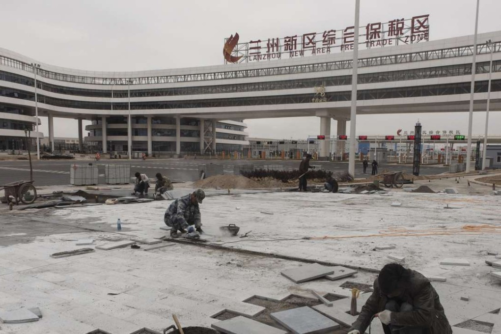 Construction workers help put the finishing touches on a new complex in the Free Trade Zone In Lanzhou New Area, Gansu province, on May 6, 2016. Photo: The Washington Post, Gilles Sabrié