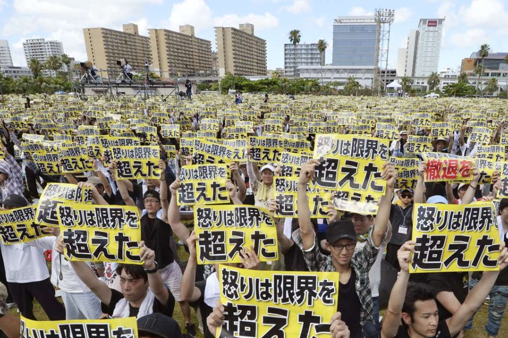 Thousands of residents carry signs saying "Our anger has reached the limit," as they rally in Naha in Japan's southernmost island prefecture of Okinawa. Photo: Kyodo