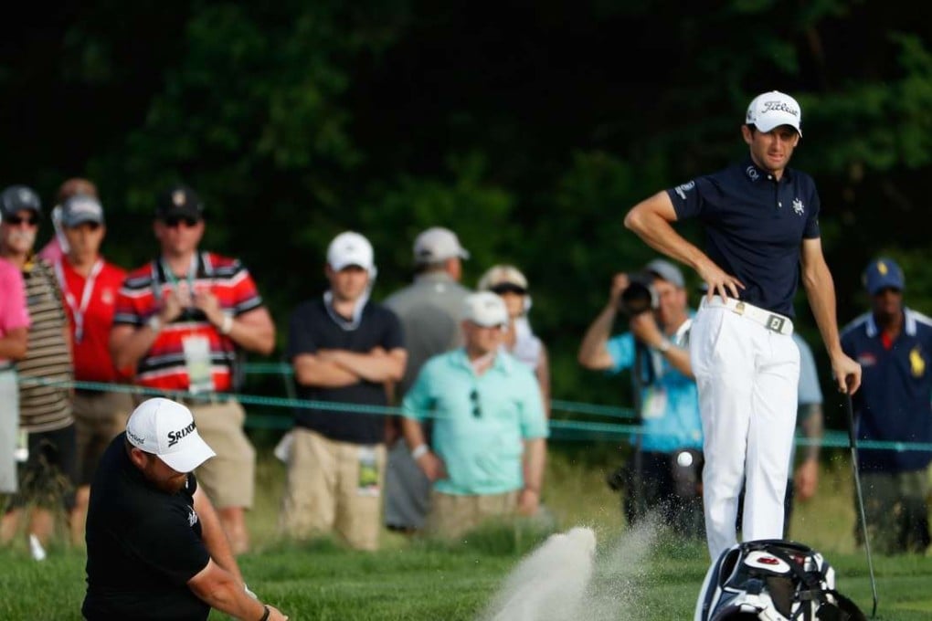 Shane Lowry chips from the bunker onto the eighth green during the third round of the US Open. Photo: AFP