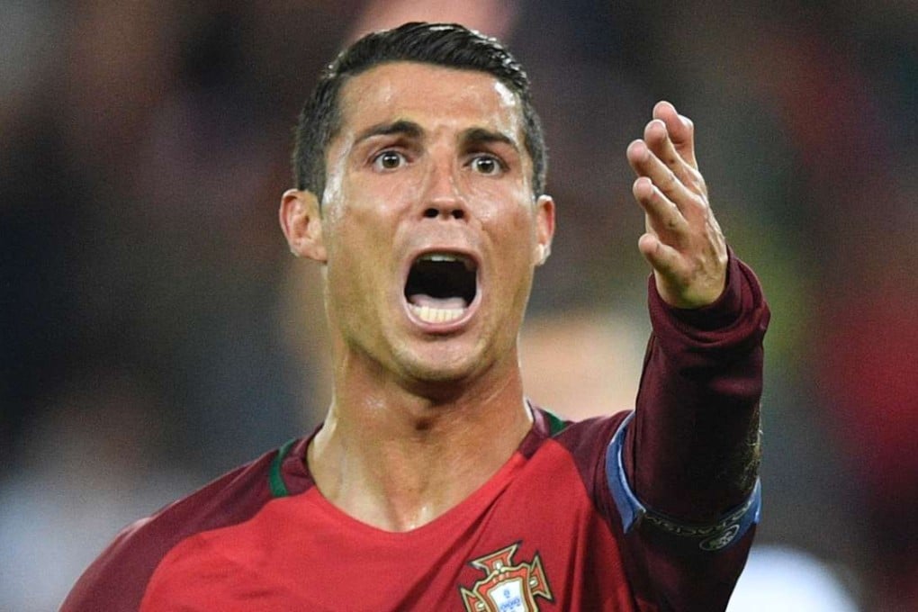 Portugal's forward Cristiano Ronaldo reacts after he missed from the spot. AFP PHOTO / MARTIN BUREAU