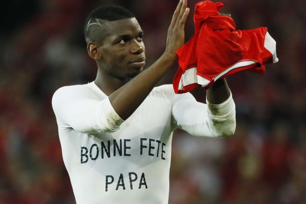 Paul Pogba applauds fans after the game with a Father’s Day t-shirt REUTERS/Gonzalo Fuentes Livepic