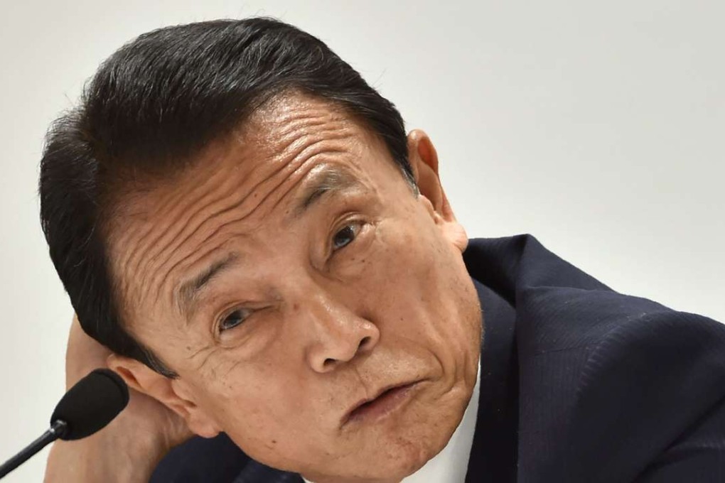 Japanese Finance Minister Taro Aso answers questions during a press conference. Photo: AFP