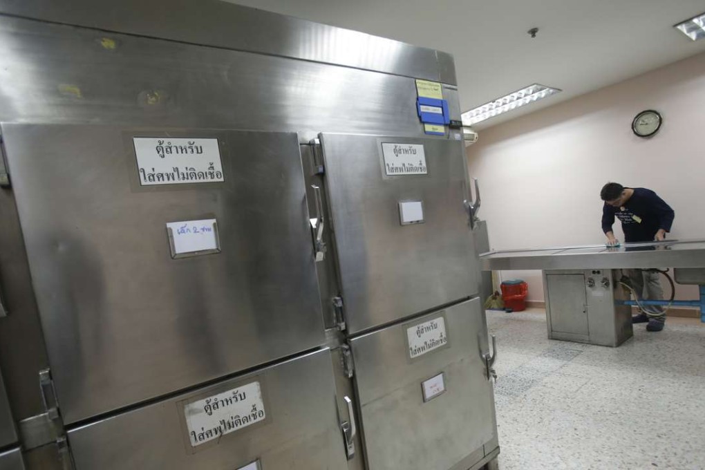 A Thai man convicted of drunk drinking cleans an autopsy table at Taksin Hospital in Bangkok. Photo: AP