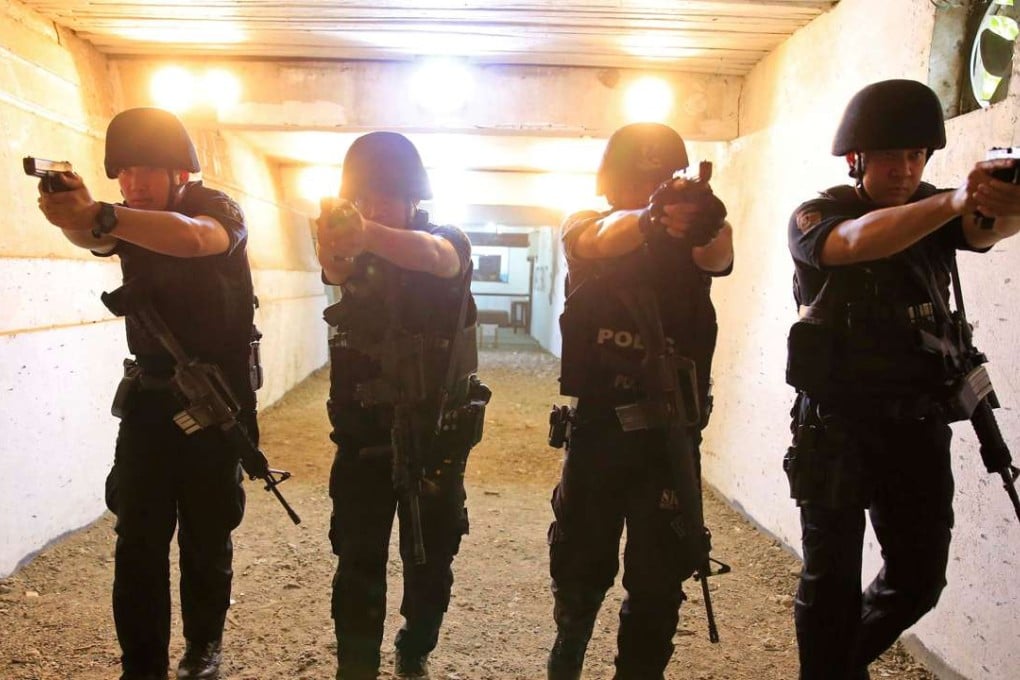 Members of the Philippine National Police Special Reactions Unit aims their pistols at a target range. Photo: Reuters