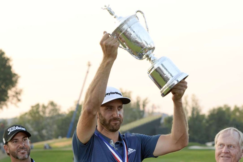 Dustin Johnson holds up the US Open trophy watched by Scott Piercy and Jack Nicklaus. Photo: USA TODAY Sports