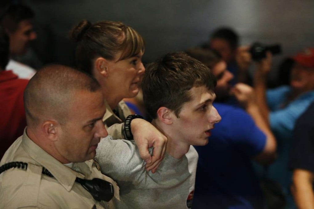 Police remove protestor Michael Steven Sandford as Republican presidential candidate Donald Trump speaks at the Treasure Island hotel and casino in Las Vegas. Photo: AP