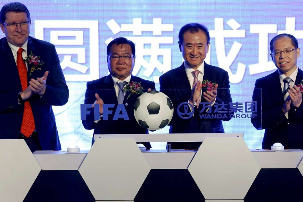 From left, FIFA’s Thierry Weil and David Chung with Dalian Wanda Group chairman Wang Jianlin and first vice president of the Football Association of the PRC Zhang Jian at an event announcing a partnership between Wanda Group and FIFA in Beijing on March 21, 2016. Photo: Reuters