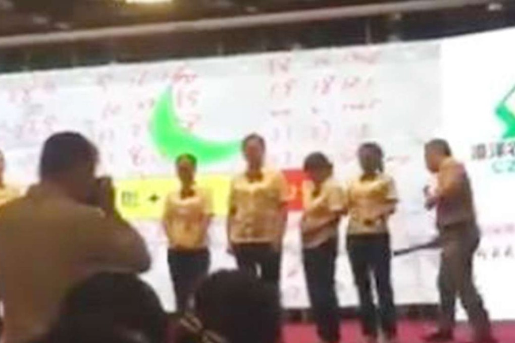 Mobile phone footage of the trainer spanking bank staff. Photo: SCMP Pictures